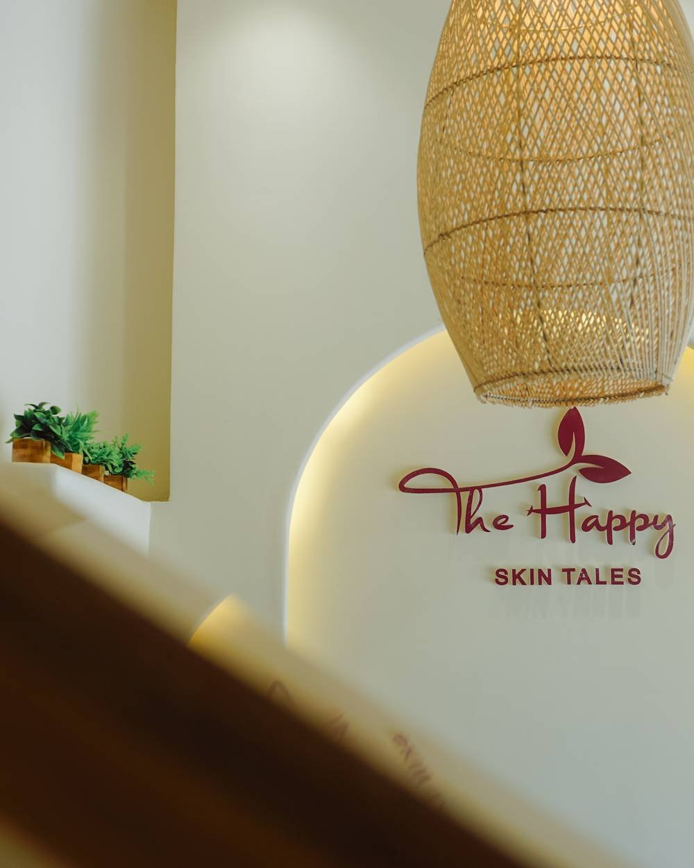 The signature illuminated arch with The Happy Skin Tales logo